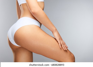 Beautiful Slim Woman Body. Closeup Of Healthy Girl With Fit Body, Soft Skin, Tight Hips And Firm Buttocks In Bikini Underwear. Perfect Female Body In Shape With Sexy Back And Big Butt. High Resolution