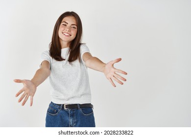 Beautiful Slim Woman Reaching Out, Stretching Hands Forward To Hold You, Wanting A Hug, Standing Over White Background