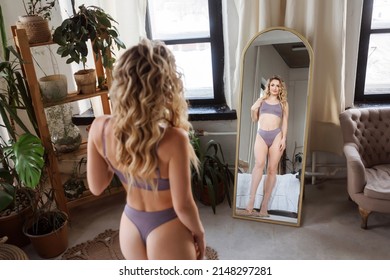 Beautiful Slim Woman In Sporty Lilac Lingere Is Looking At Herself In The Mirror.