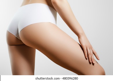Beautiful slim woman's body. Perfect slim toned young body of the young girl. Fitness or plastic surgery and aesthetic cosmetology. Perfect buttocks