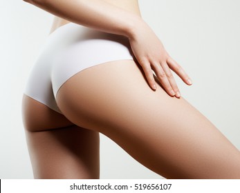 Beautiful slim woman's body. Perfect slim toned young body of the girl. Fitness or plastic surgery and aesthetic cosmetology. Taut elastic ass. Firm buttocks
