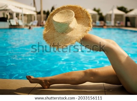 Beautiful slim women legs by the swimming pool