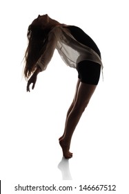 Beautiful Slim Young Female Modern Jazz Contemporary Style Ballet Dancer In Silhouette Wearing A Black Leotard And White Shirt Isolated On A White Studio Background