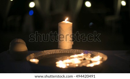 Beautiful small burning candles floating in the water