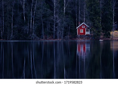 Beautiful small cabin in the beach of the lake in Finnish countryside. Dark, mystical atmosphere.
 - Powered by Shutterstock