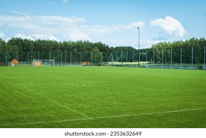 Beautiful small football training ground located among pine forests. Jacnia, Poland - Powered by Shutterstock