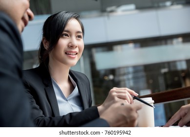 Beautiful smart and confident smiling Asian woman leader meeting with client at office building lobby lounge