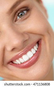 Beautiful Smile. Closeup Of Beautiful Happy Smiling Woman With White Teeth And Fresh Face. Beauty Girl With Cosmetic Lip Balm On Her Full Lips. Dental Health, Lip Care Concept. High Resolution Image