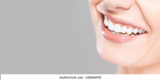 Beautiful smile young woman. White teeth on the master plan. Free space and background to use.