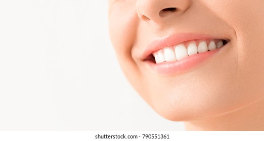 Beautiful smile young woman. White teeth on the master plan. Free space and background to use.