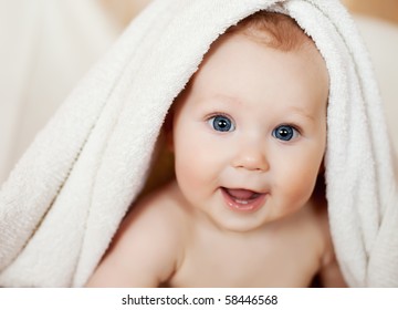 A Beautiful Smiling Baby Wrapped In Quilt