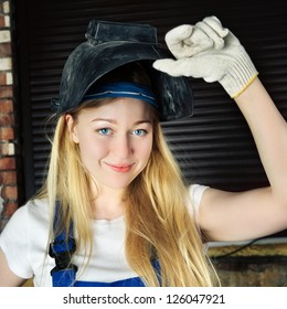 Beautiful Smiling Blond Woman In Welder Helmet