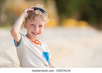 Beautiful Smiling Boy Enjoying Summer Vacation At Anguilla Island At Sunset