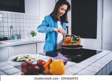 Beautiful smiling brunette woman cooking in the kitchen at home healthy food, attractive young girl preparing vegetarian food at home, organic food lifestyle