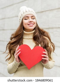 Beautiful Smiling Brunette Woman In Hat. Winter Season. With Red Heard.