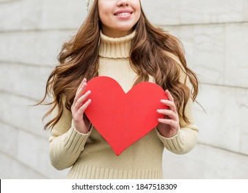 Beautiful Smiling Brunette Woman In Hat. Winter Season. With Red Heard.