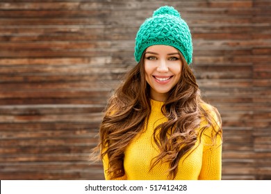 Beautiful Smiling Brunette Woman With Luxurious Hair Over Wooden Background. Autumn Time. Fall Season.