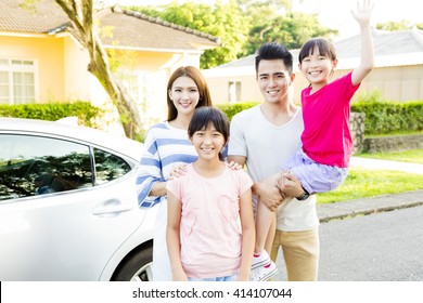 Beautiful Smiling Family Portrait  Outside Their  House