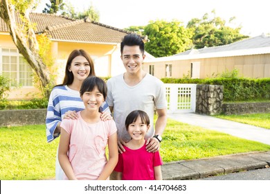 Beautiful Smiling Family Portrait  Outside Their  House