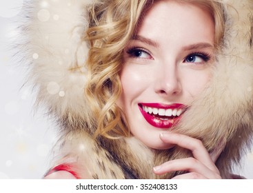 Beautiful Smiling Fashion Model Face With Red Lips And Fur Hood