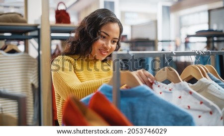 Beautiful Smiling Female Customer Shopping in Clothing Store, Choosing Stylish Clothes, Picking Dress, Blouse. People in Fashionable Shop, Colorful Brand, Sustainable Designs, New Seasonal Collection.