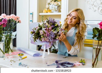 beautiful smiling female florist in apron arranging bouquet in flower shop  - Powered by Shutterstock