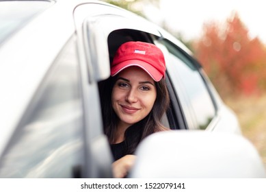 beautiful smiling girl driving with open window - Shutterstock ID 1522079141