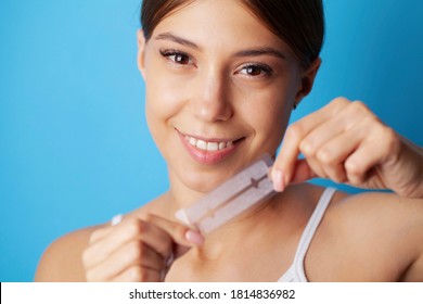 Beautiful Smiling Girl Holding Teeth Whitening Strip