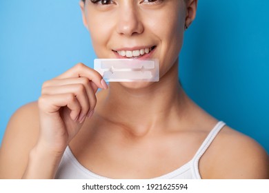 Beautiful Smiling Girl Holding Teeth Whitening Strip