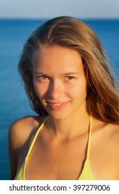Beautiful smiling girl on sea background.
