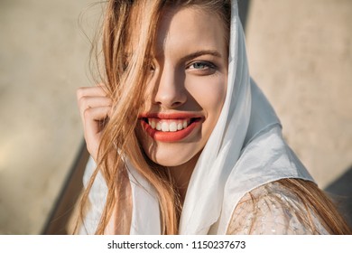 Beautiful Smiling Girl In White Silk Scarf Looking At Camera