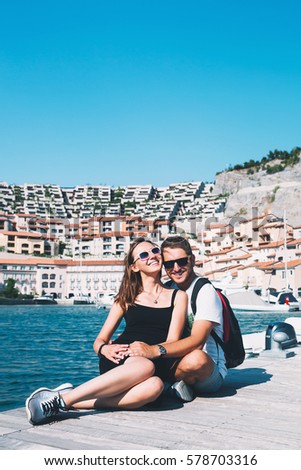 Beautiful smiling happy couple in love walking in Portopiccolo Sistiana, Italy, Europe. Lifestyle, Holidays and Travel Concept.