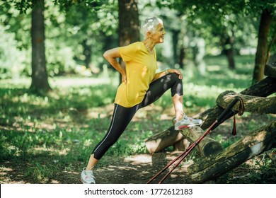 Beautiful Smiling Mature Woman Stretching Legs After Nordic Walking Exercise. 