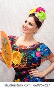 Beautiful Smiling Mexican Woman In Traditional Mexican Dress With Fan 