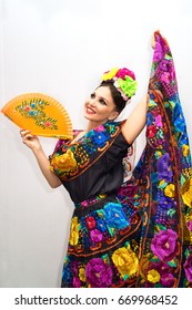 Beautiful Smiling Mexican Woman In Traditional Mexican Dress With Fan 