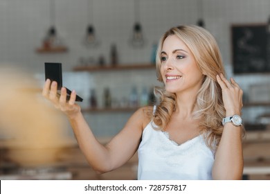 Beautiful Smiling Middle Aged Woman Looking At Cosmetic Mirror