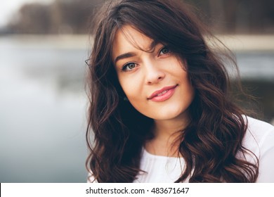 Beautiful smiling plump girl. Closeup portrait of gorgeous woman looking to camera