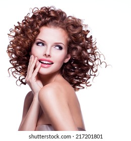 Beautiful Smiling Thoughtful Woman With Curly Hair Posing At Studio Over White Background.