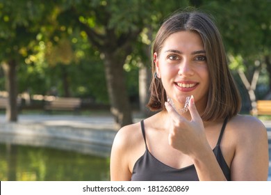 Beautiful Smiling Turkish Woman Is Holding An Invisalign Bracer