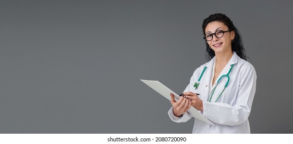 Beautiful Smiling Turkish Young Doctor Woman Portrait. She Wears Eyeglasses. She Is Confident Mood. She Is Taking Note.