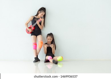 Beautiful Smiling Two Little Girl In Black Clothes. Jazz Dance Practicing Some Dance Moves In A Dance Academy