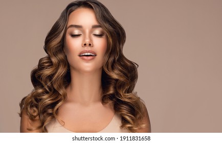 Beautiful smiling woman with long wavy hair .  Dreaming girl curly hairstyle . Beauty ,makeup and cosmetics . - Shutterstock ID 1911831658
