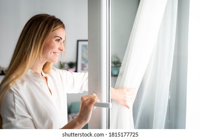 Beautiful Smiling Woman Opening Window At The Morning