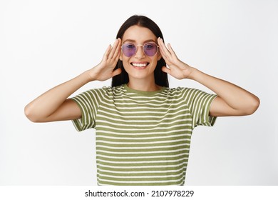 Beautiful Smiling Woman Put On Sunglasses, Looking Happy, Wearing Summer Clothes, White Background