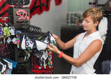 Beautiful Smiling Woman Shopping In Retail Store,woman Buys In The Store Swimsuit