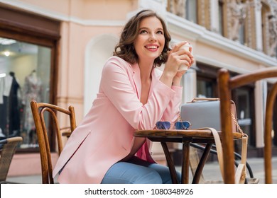 Beautiful Smiling Woman In Stylish Outfit Sitting At Table Wearing Pink Jacket, Romantic Happy Mood, Waiting For Boyfriend On A Date In Cafe, Spring Summer Fashion Trend, Drinking Coffee