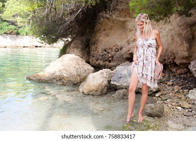 Beautiful Smiling Woman Visiting Beach Retreat On Summer Holiday, Dipping Tip Toes In Sea Water, Testing Temperature Outdoors. Healthy Tourist Woman Relaxing By The Sea, Wellness Recreation Lifestyle.