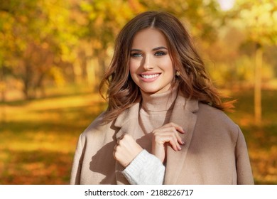 Beautiful smiling woman walking outdoors in autumn - Shutterstock ID 2188226717