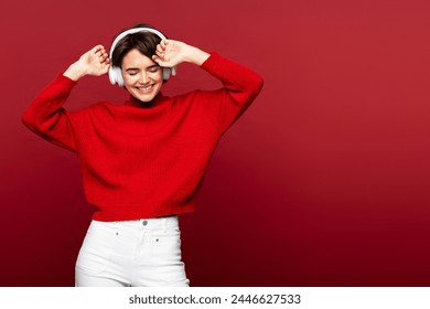 Beautiful smiling woman wearing headphones listening to music, looking away isolated on red background, dancing, having fun. Happy lifestyle concept - Powered by Shutterstock