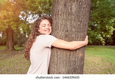 Beautiful Smiling Young Positive And Happy Environmentalist Girl Hugging The Big Tree In The Park Love The Nature And Want To Protect Environment Environmental Concept Save The Forest